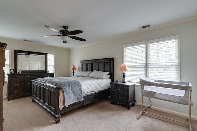 carpeted bedroom featuring ceiling fan and crown molding