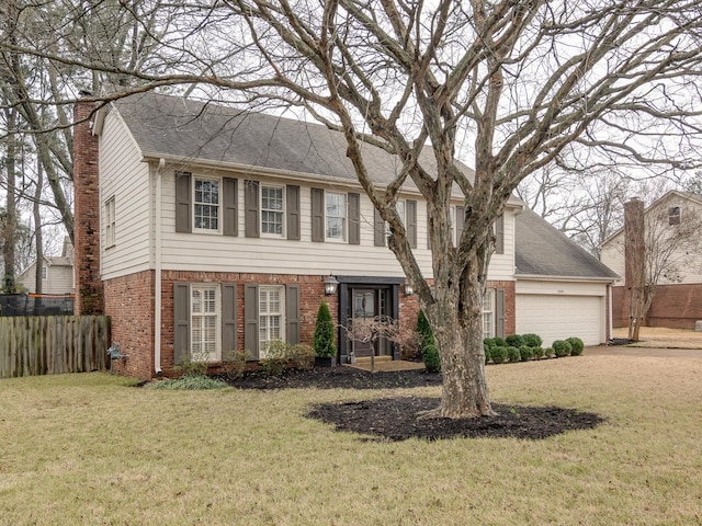 colonial inspired home with a garage and a front yard