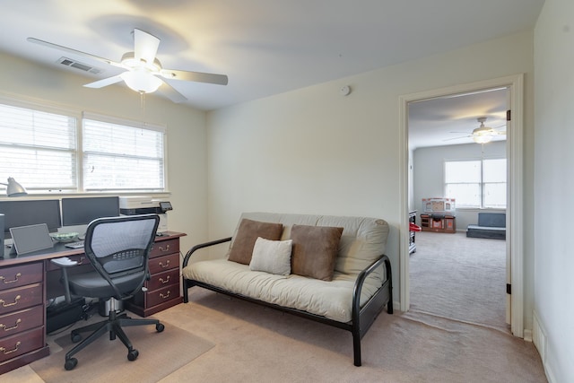 carpeted office space with ceiling fan