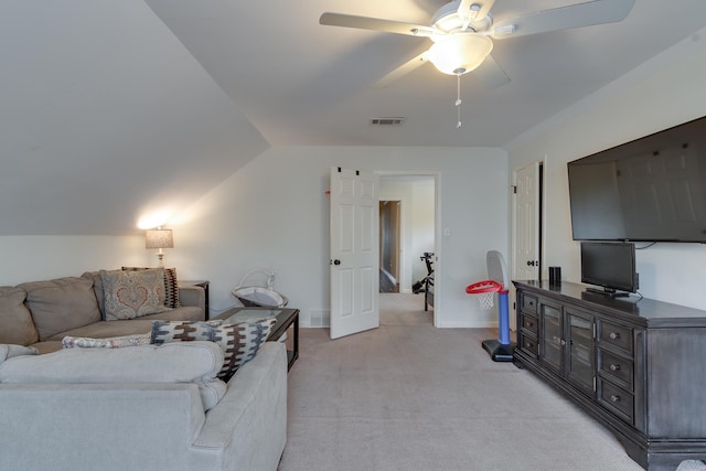 carpeted living room with ceiling fan and lofted ceiling