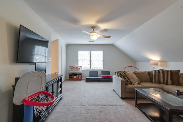 carpeted living room with ceiling fan and lofted ceiling