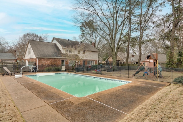 view of swimming pool with a playground, a patio area, and a lawn