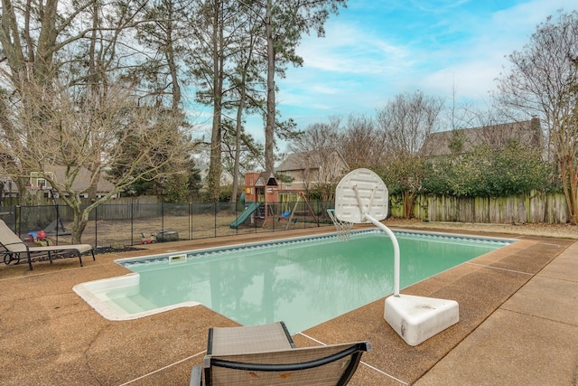 view of swimming pool featuring a playground and a patio area