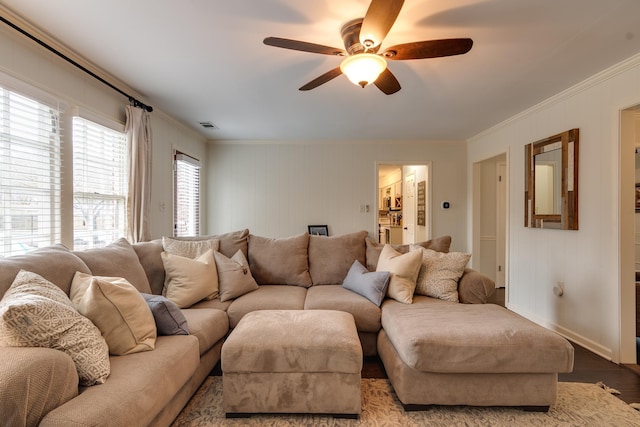 living room with ceiling fan, crown molding, and light wood-type flooring