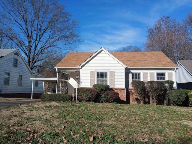 view of front facade with a carport and a front lawn