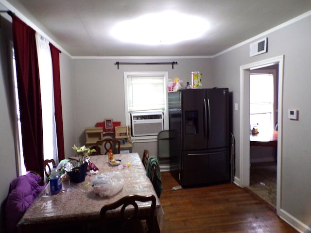 dining area with crown molding, cooling unit, and dark wood-type flooring