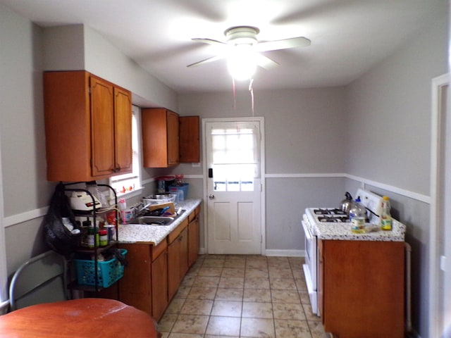 kitchen with ceiling fan, sink, and white stove