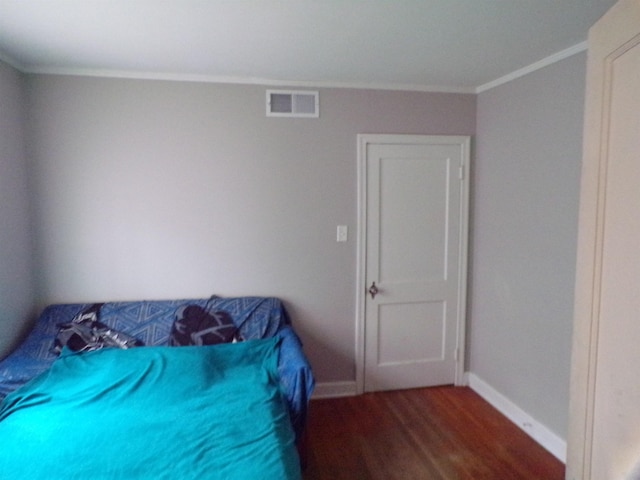 bedroom featuring crown molding and hardwood / wood-style flooring