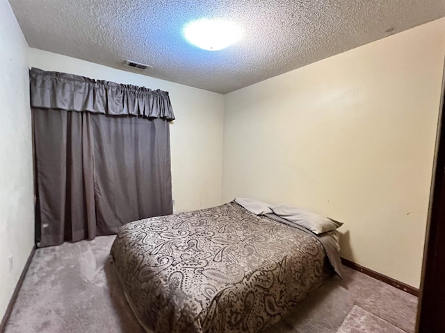 carpeted bedroom with a textured ceiling