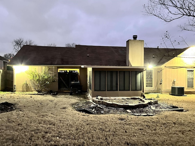 back of house with central AC unit