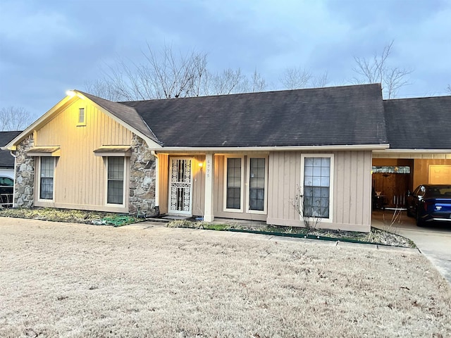 ranch-style house featuring a carport