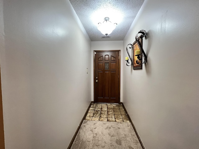 entryway featuring a textured ceiling