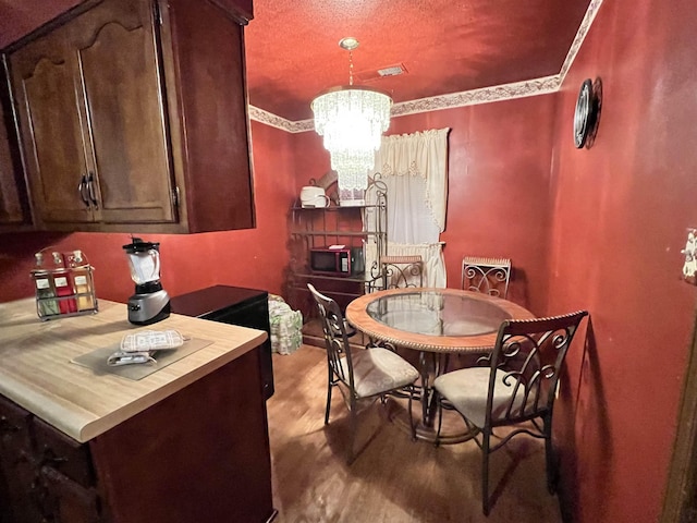 dining area featuring light hardwood / wood-style flooring and a chandelier