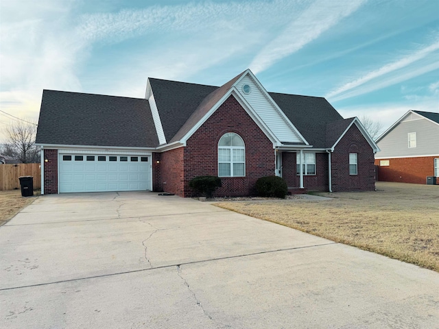 view of front of home with a garage, a front yard, and cooling unit