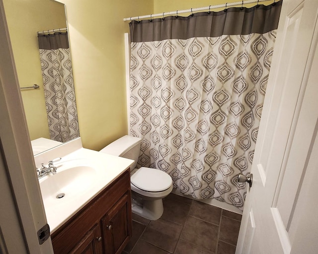 bathroom with vanity, tile patterned floors, toilet, and walk in shower