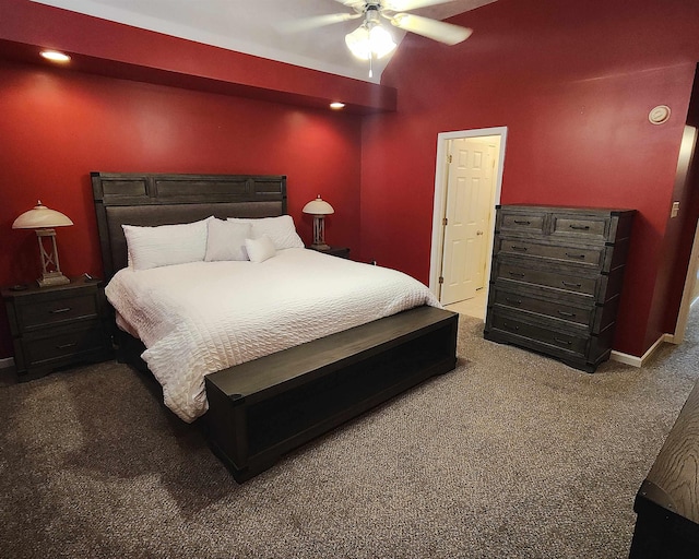 bedroom with lofted ceiling, dark carpet, and ceiling fan