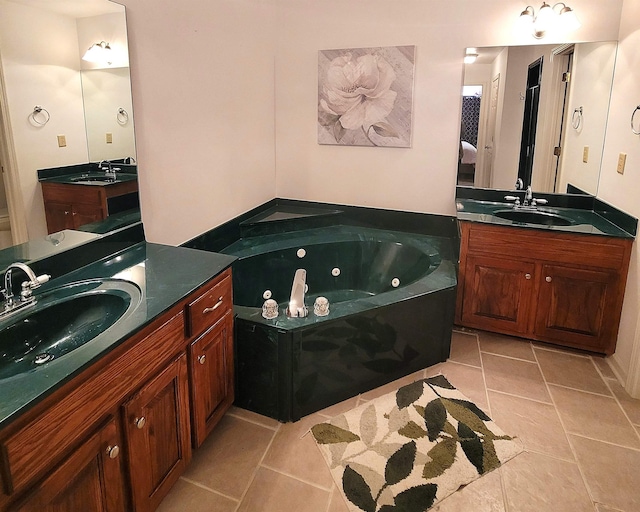 bathroom featuring vanity, a bath, and tile patterned floors