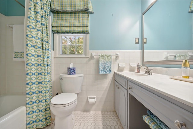 full bathroom featuring shower / tub combo, tile patterned floors, vanity, tile walls, and toilet