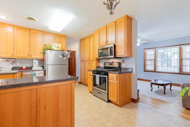 kitchen with ceiling fan, ornamental molding, light brown cabinetry, and appliances with stainless steel finishes