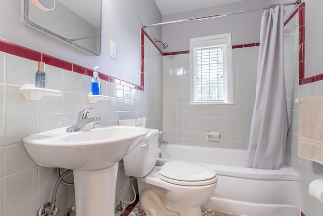 bathroom with shower / bath combination with curtain, toilet, and tile walls