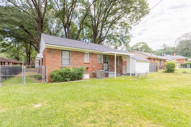 rear view of property with central AC unit and a lawn