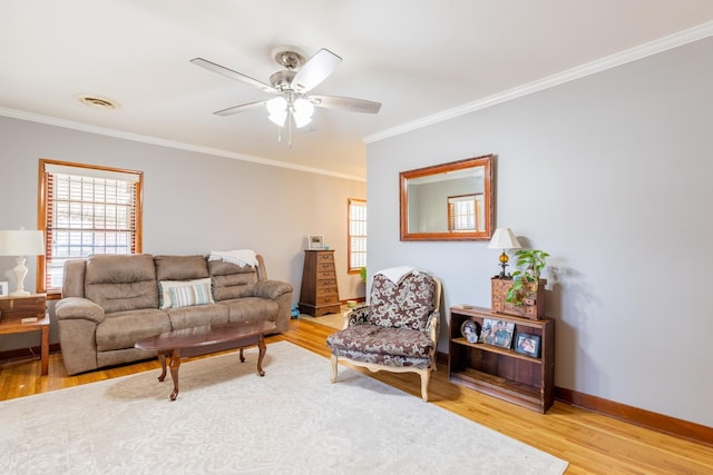 living room featuring hardwood / wood-style flooring, ceiling fan, and ornamental molding