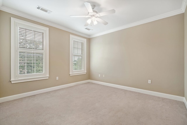 carpeted spare room with ceiling fan and ornamental molding