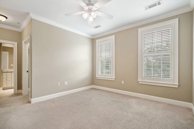 unfurnished room with ceiling fan, light colored carpet, and ornamental molding