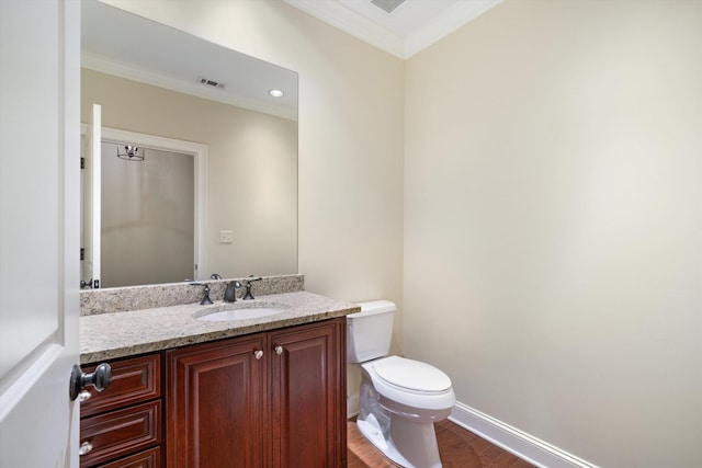 bathroom with vanity, hardwood / wood-style flooring, toilet, and crown molding