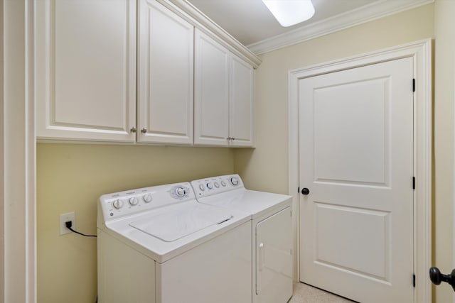 laundry area with cabinets, washer and clothes dryer, and ornamental molding