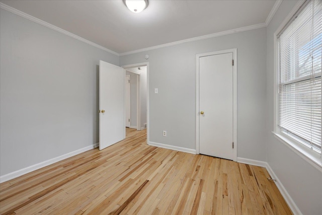 unfurnished bedroom with crown molding and light hardwood / wood-style floors