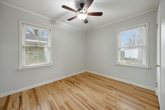 empty room featuring light hardwood / wood-style flooring, a healthy amount of sunlight, and ornamental molding