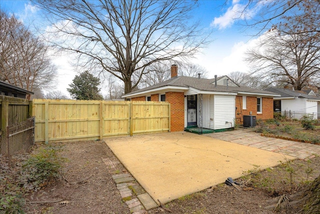 rear view of house with central AC