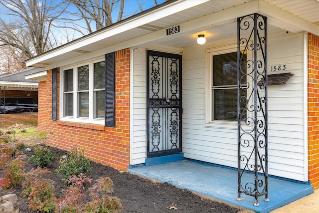 view of exterior entry with a porch