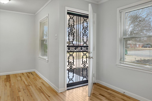 entryway featuring light hardwood / wood-style flooring and ornamental molding