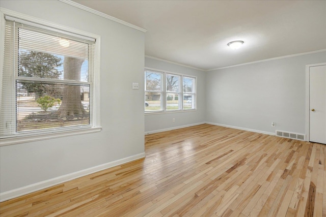 spare room featuring light hardwood / wood-style floors and ornamental molding