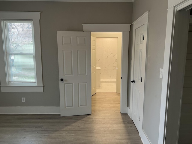 corridor with wood-type flooring