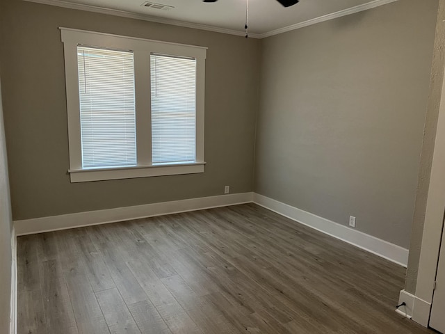 spare room with hardwood / wood-style flooring, ceiling fan, and ornamental molding