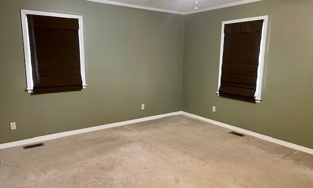 carpeted spare room featuring ceiling fan and crown molding