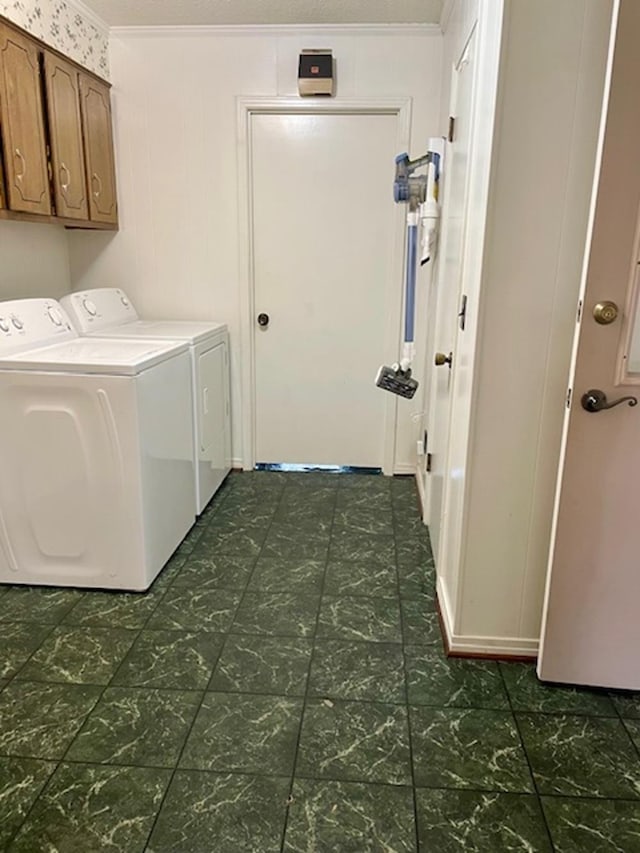 laundry room featuring washer and dryer, cabinets, ornamental molding, and a textured ceiling