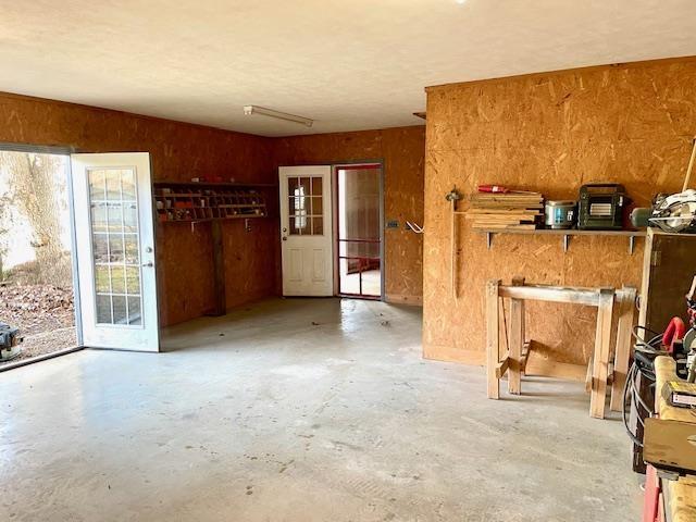 unfurnished room with concrete flooring