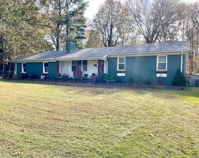 single story home with cooling unit and a front lawn