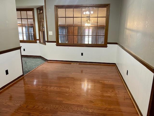 unfurnished room with dark hardwood / wood-style floors