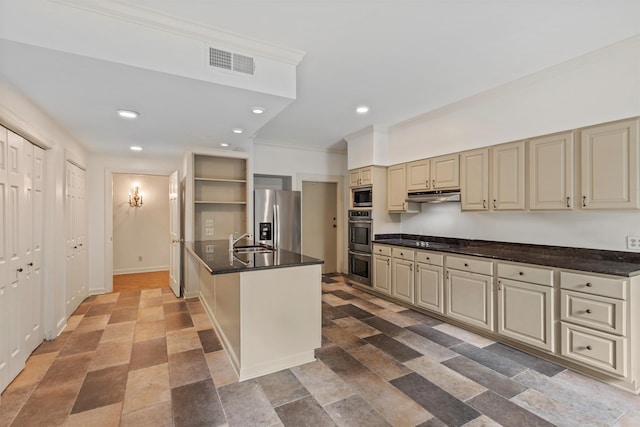 kitchen with cream cabinetry, ornamental molding, sink, and appliances with stainless steel finishes