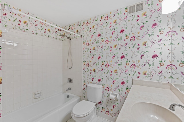 full bathroom with vanity, toilet, and tiled shower / bath