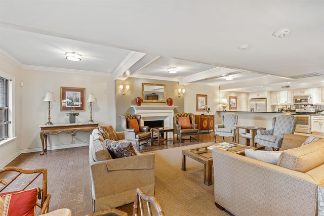 living room featuring beamed ceiling and ornamental molding