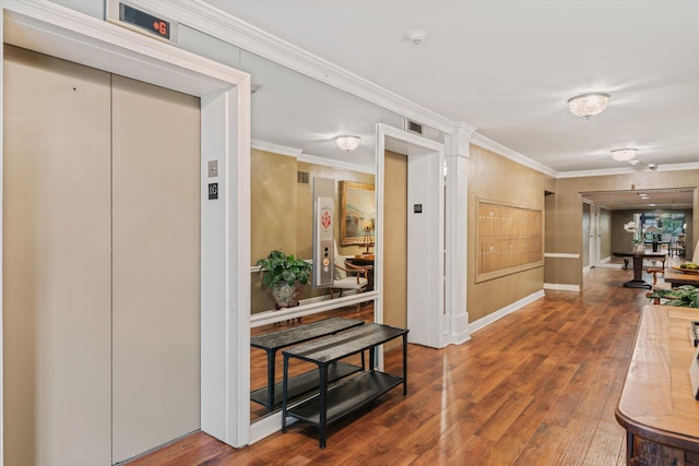 hall with elevator, hardwood / wood-style flooring, and ornamental molding