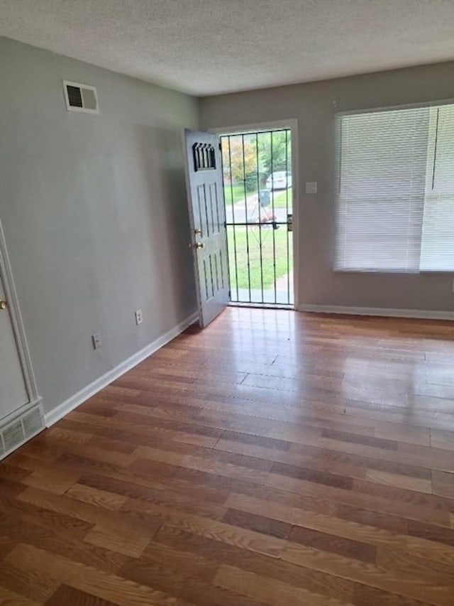 interior space with dark hardwood / wood-style flooring and a textured ceiling