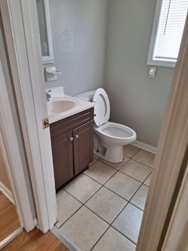 bathroom featuring tile patterned flooring, vanity, and toilet