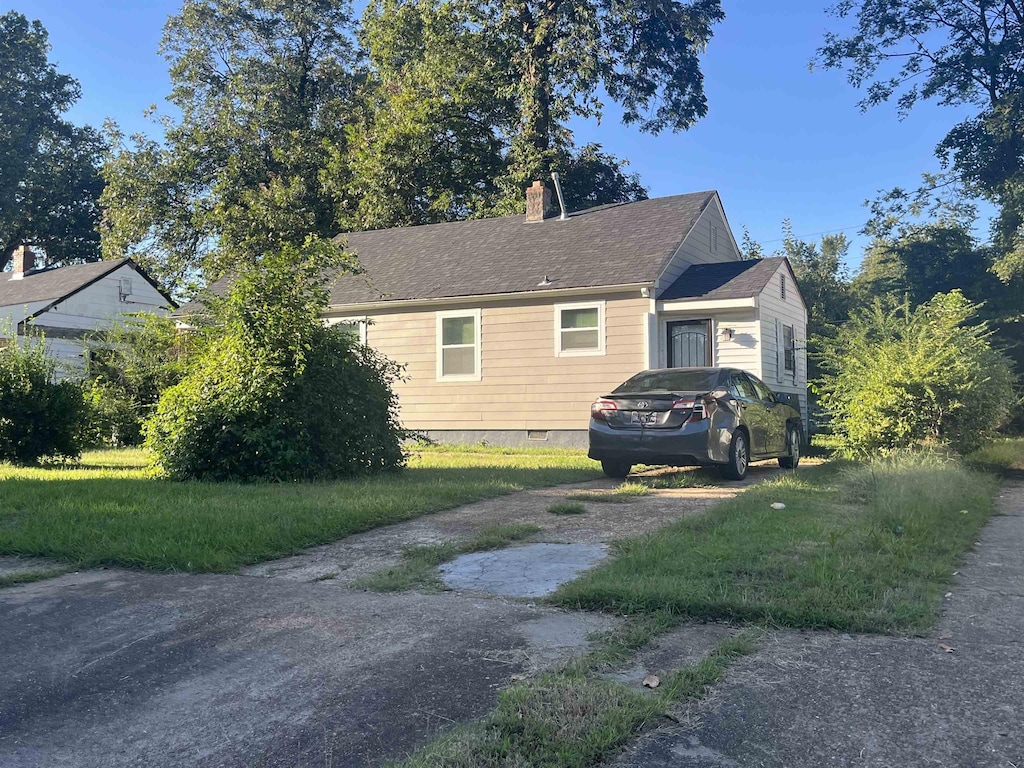 view of home's exterior with a lawn